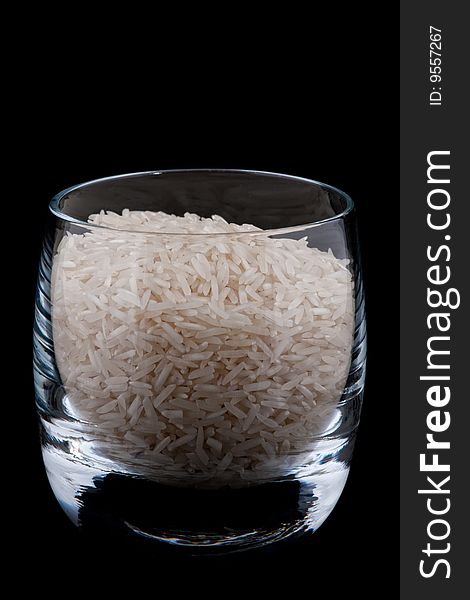 Basmati rice in glass, isolated on black background. Basmati rice in glass, isolated on black background