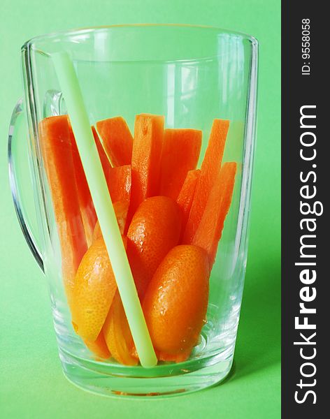 Juicy carrot bars with kumquats in transparent glass. Juicy carrot bars with kumquats in transparent glass