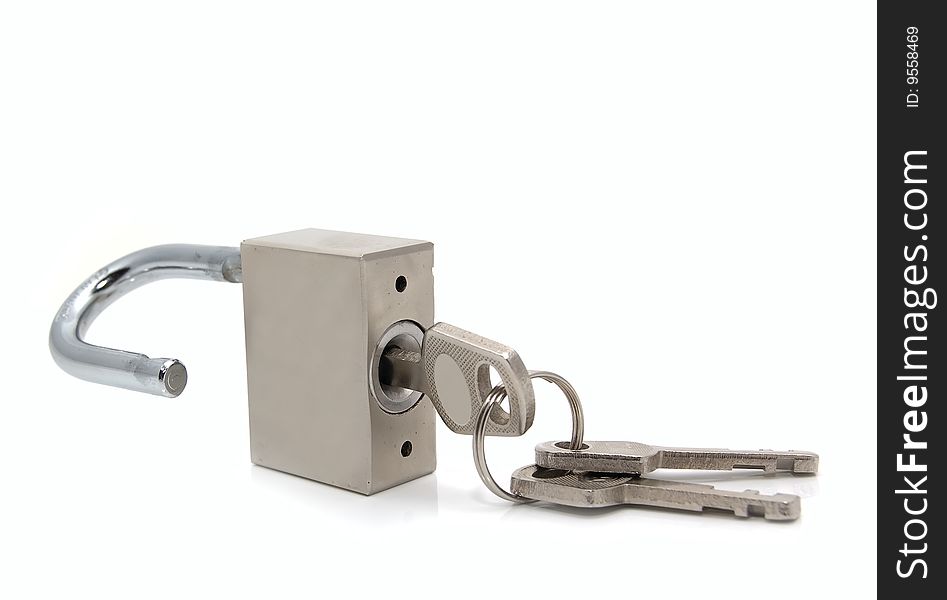 Opened steel padlock with keys on a white background. Close-up. Macro.