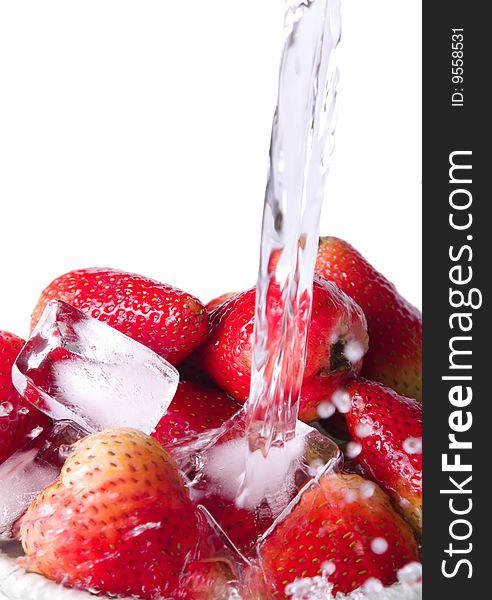 Pouring water on strawberries on a white background. Pouring water on strawberries on a white background