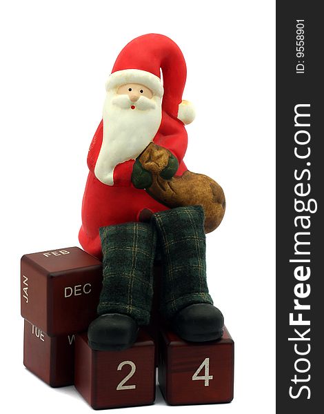 Santa Clause figurine standing on calendar cubes. Santa Clause figurine standing on calendar cubes