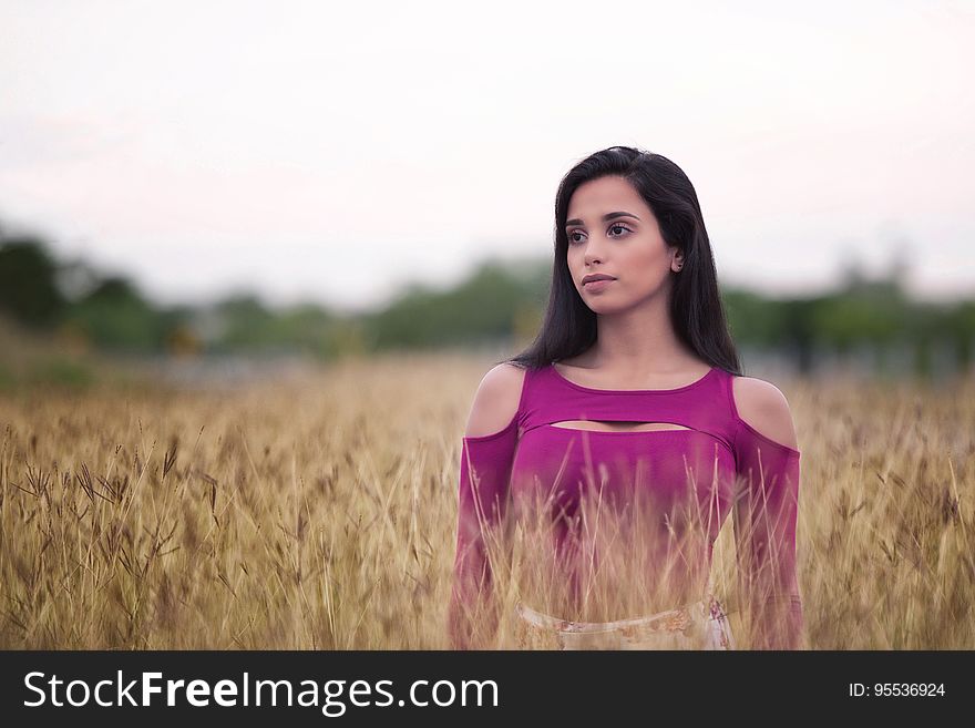 Woman Standing In Wheat Field