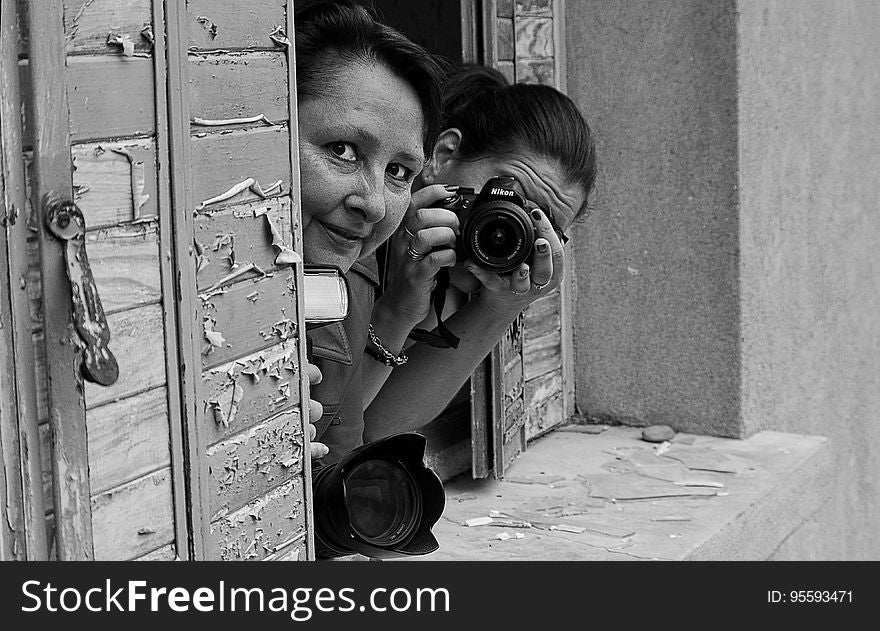 Grayscale Photo Of 2 Woman On Window Pane