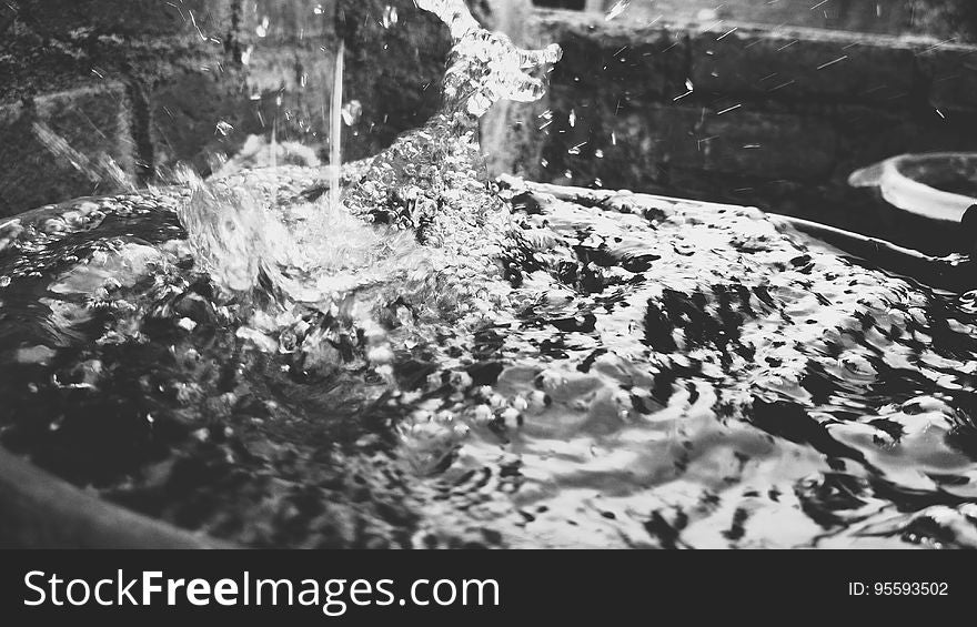 Close up of flowing and splashing water in black and white.