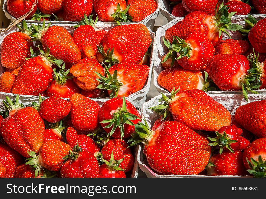 Boxes of fresh red ripe strawberries in sunshine. Boxes of fresh red ripe strawberries in sunshine.