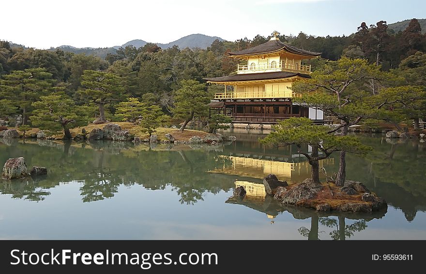 Kinakaku-Ji temple reflecting in waterfront on lake in Kyoto, Japan on sunny day. Kinakaku-Ji temple reflecting in waterfront on lake in Kyoto, Japan on sunny day.