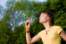 Young Woman And Soap-bubbles Stock Images