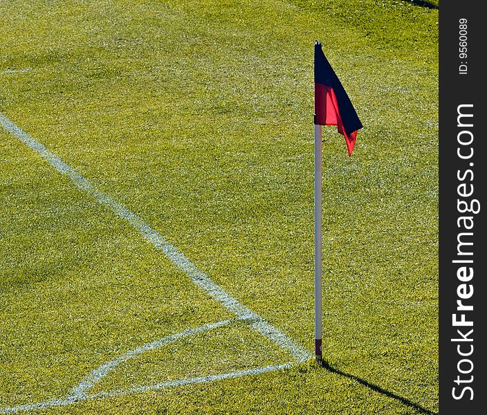 Corner on football pitch with red anb blue flag. Corner on football pitch with red anb blue flag