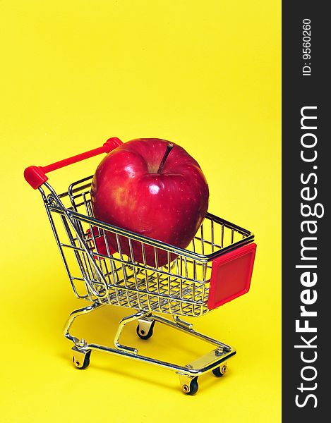 Large apple in a shopping cart,