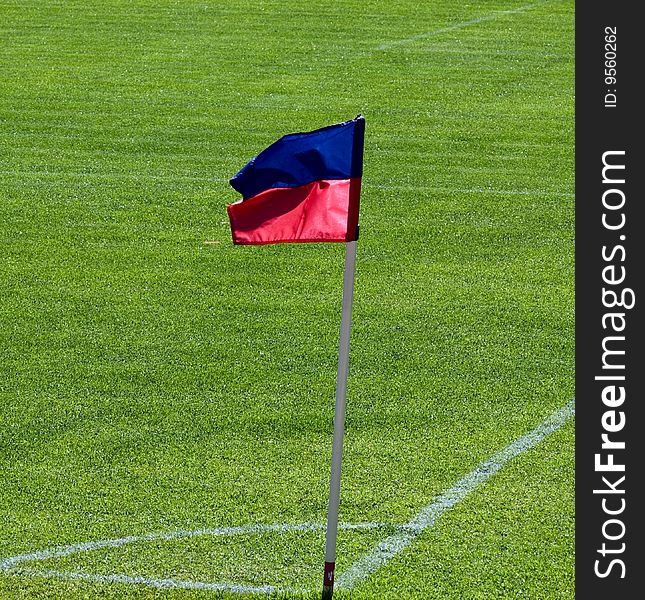 Corner on football pitch with red anb blue flag. Corner on football pitch with red anb blue flag