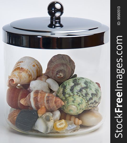 Seashells and beach agates in a jar. Seashells and beach agates in a jar