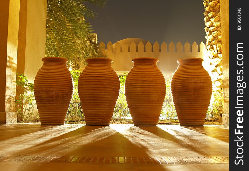 Four clay vases projecting a shadow lit from the back. Four clay vases projecting a shadow lit from the back