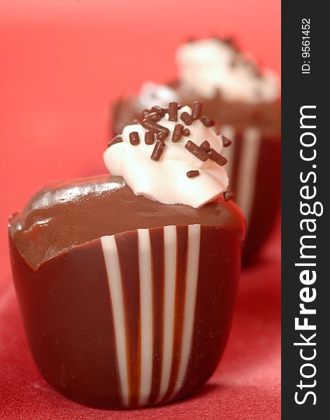 Chocolate pudding in a dark and white chocolate cup with whipped cream. Chocolate pudding in a dark and white chocolate cup with whipped cream