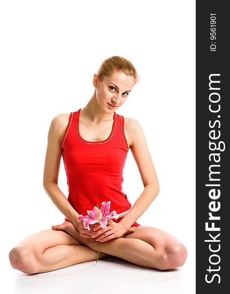 A nice blond girl in red posing with a pink lily on a white background. A nice blond girl in red posing with a pink lily on a white background