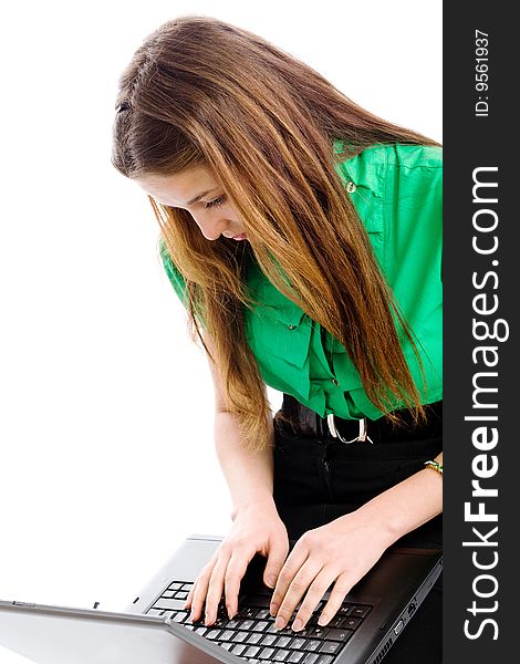 A pretty girl working with a laptop on a white background. A pretty girl working with a laptop on a white background