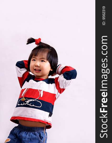 Picture of a little chinese girl with pigtail standing and laughing happily