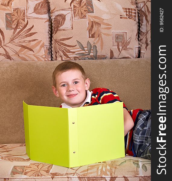 Portrait of  boy laying on a sofa of the house. Portrait of  boy laying on a sofa of the house