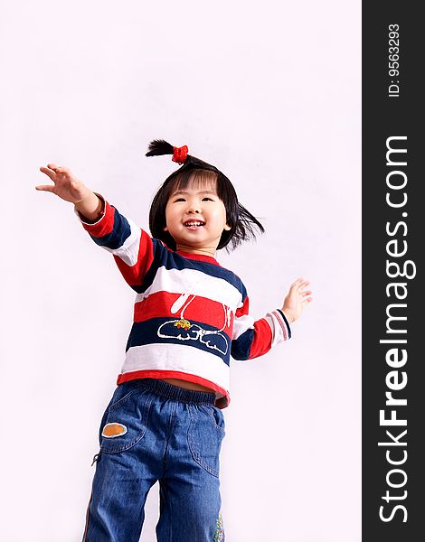 Picture of a little chinese girl with pigtail jumping and laughing happily