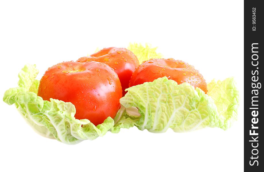 Three tomatoes on salad, on a white background, it is isolated. Three tomatoes on salad, on a white background, it is isolated.