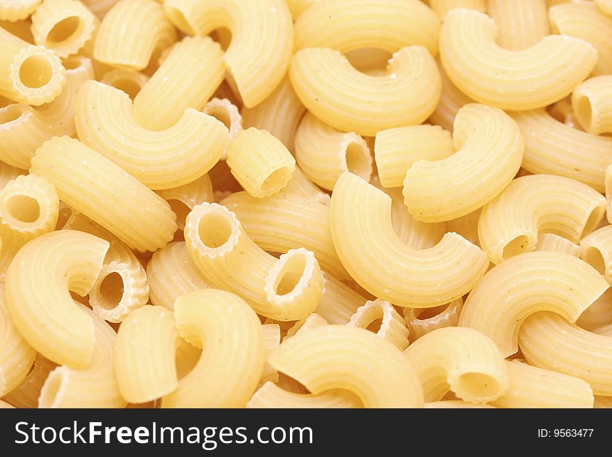 A macro shot of a heap of elbow noodles.