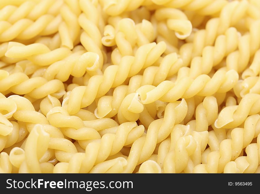 A macro shot of a heap of gemelli pasta.