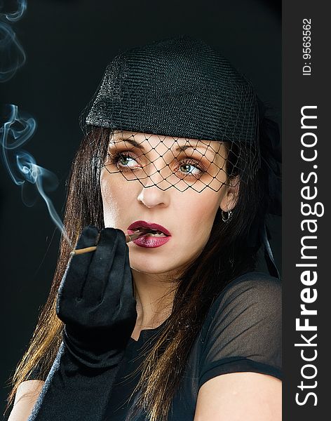 Young beautiful woman with steaming cigarette on black. Young beautiful woman with steaming cigarette on black