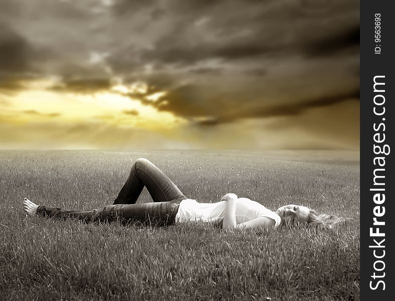 Young woman lying on grass field. Young woman lying on grass field