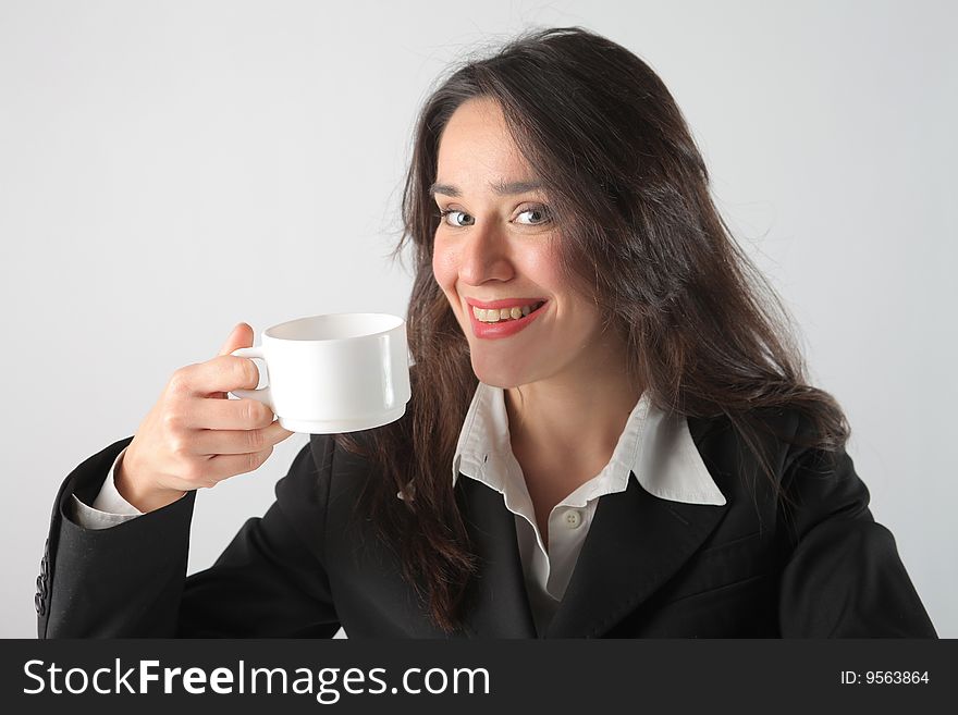 Smiling business woman drinking cup of coffee. Smiling business woman drinking cup of coffee