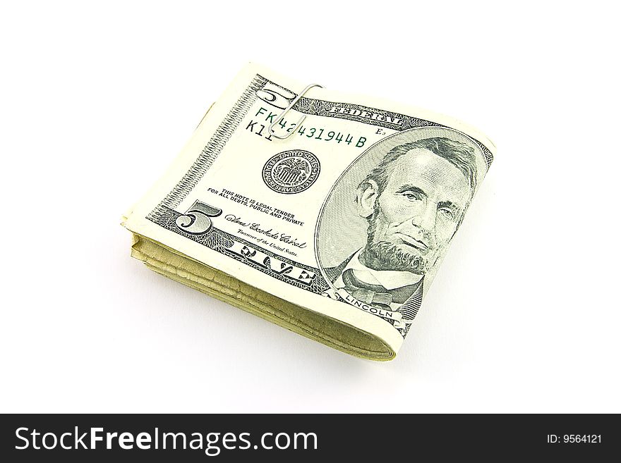 Fold of single dollar bills with paper clip on a white background. Fold of single dollar bills with paper clip on a white background