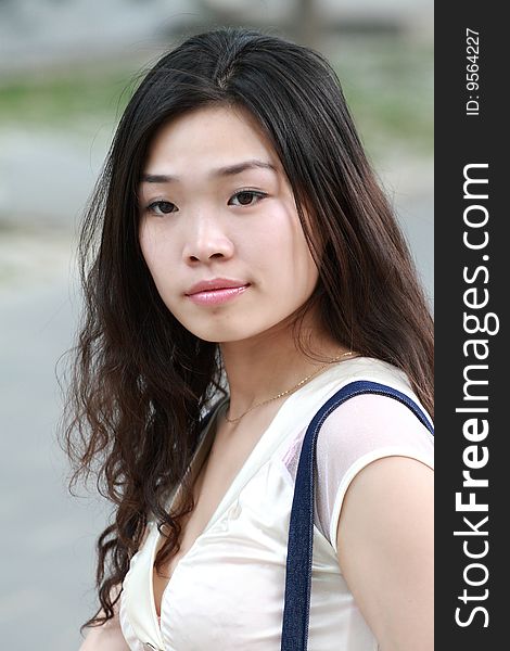 A modern asian girl's portrait outdoors. A modern asian girl's portrait outdoors.