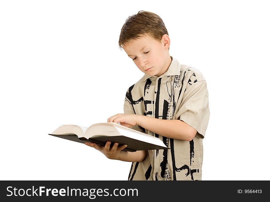 Young school boy studying a book