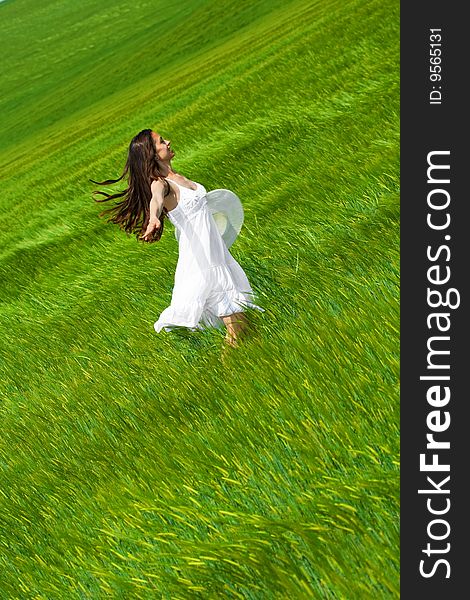 Woman dancing and running in a green field. Woman dancing and running in a green field