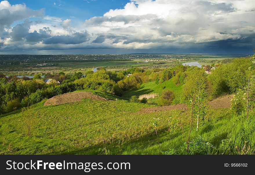 Rural landscape with cloudy evening sky