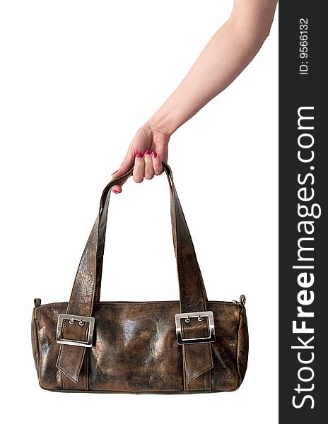 Woman's leather bag in hand isolated on white.