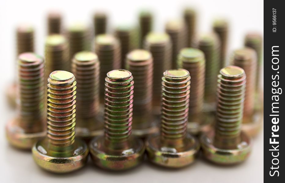 Metal bolts in row isolated on white background