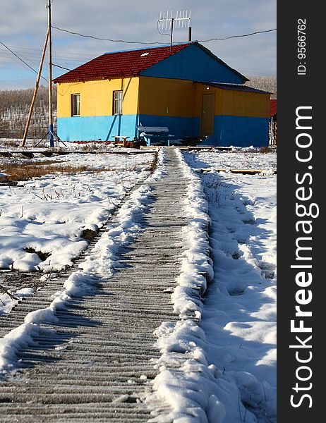 Road to the yellow house in snow. Road to the yellow house in snow