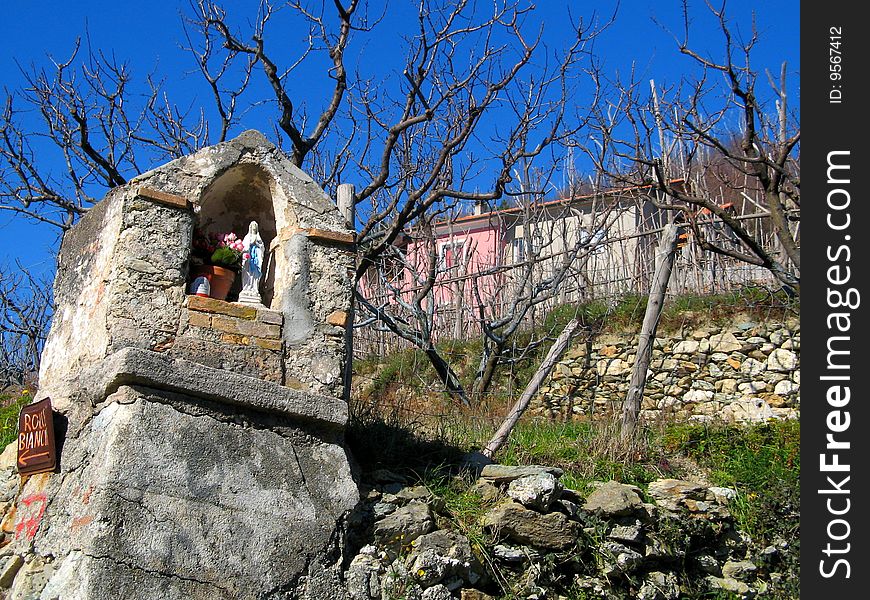 rustic religion architecture, virgin mary chapel in orchard. rustic religion architecture, virgin mary chapel in orchard