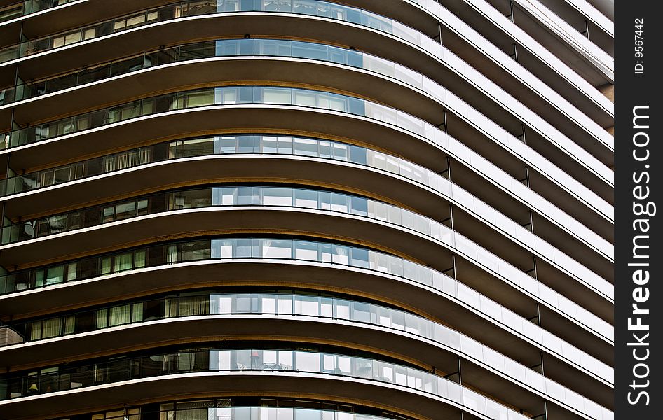 A modern NYC building with wrap around balconies creating a linear and angular abstract. A modern NYC building with wrap around balconies creating a linear and angular abstract