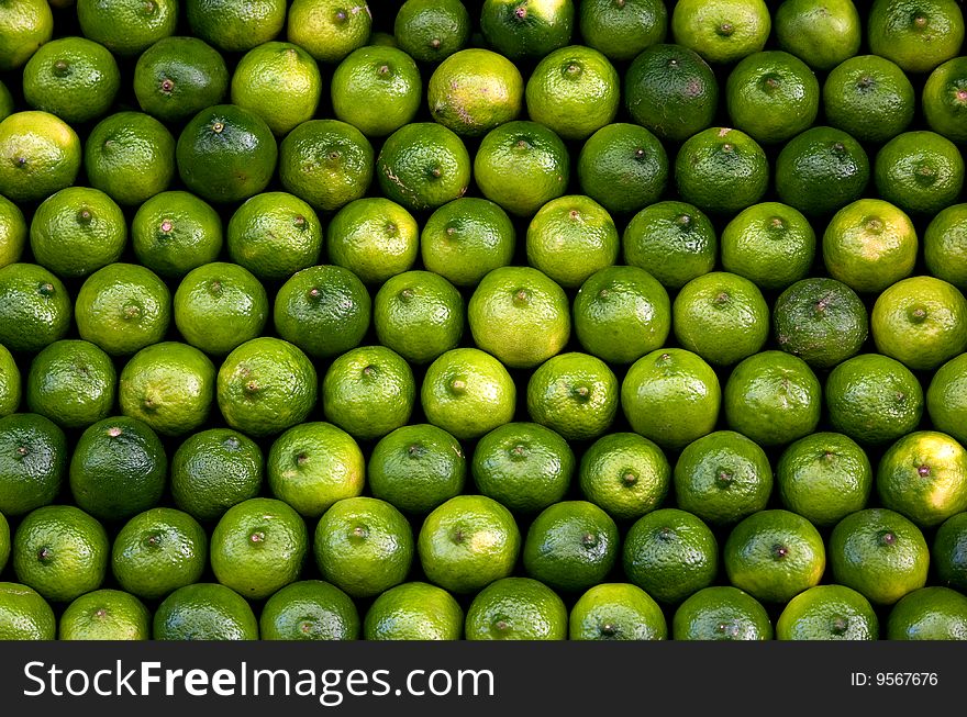 A full shot abstract of fresh whole limes that fill the image. A full shot abstract of fresh whole limes that fill the image.