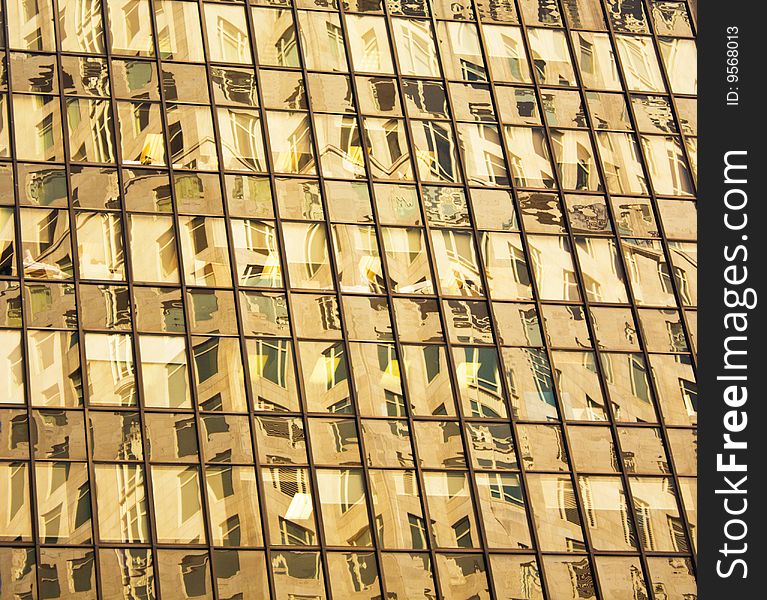 A modern NYC building with windows reflecting other buildings windows. A modern NYC building with windows reflecting other buildings windows.