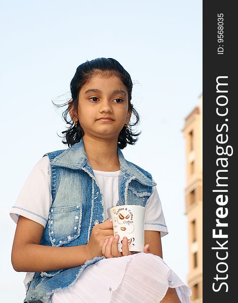 A small Indian girl engrossed in her beautiful tender thoughts. A small Indian girl engrossed in her beautiful tender thoughts.