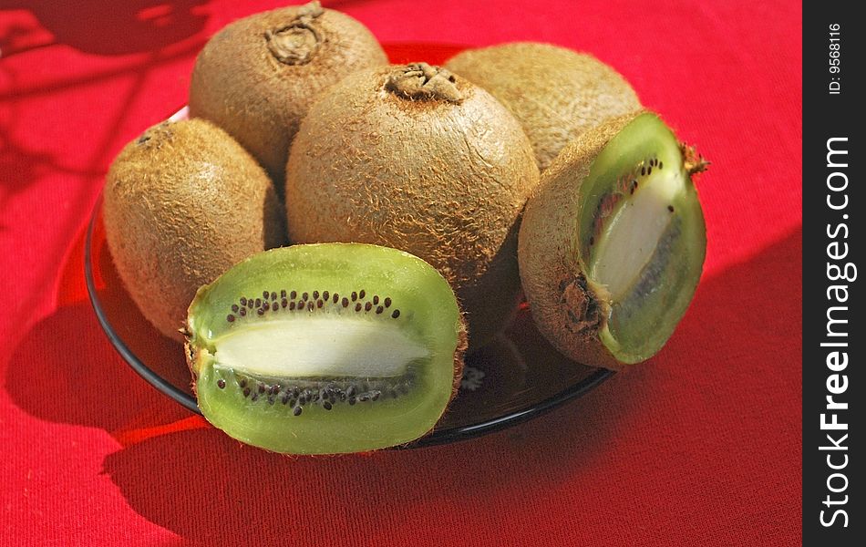 Some kiwi on red tablecloth