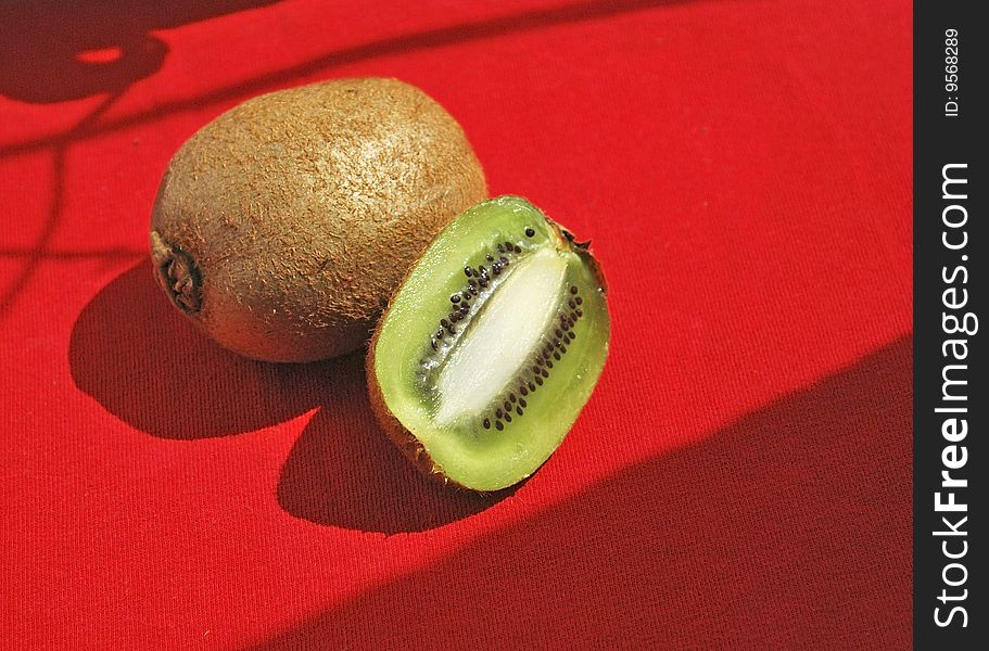 Some kiwi on red tablecloth
