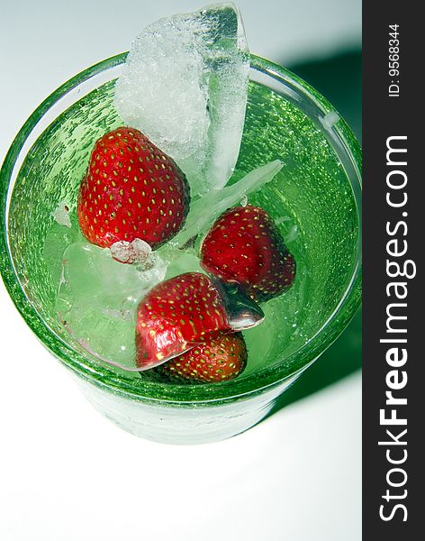 Strawberry drink in green glass with ice