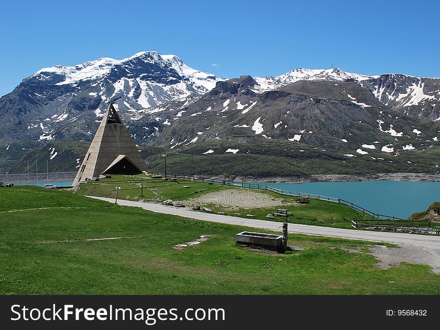 Snow capped mountain, lake, and a church. Snow capped mountain, lake, and a church