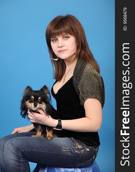 The girl with the doggie on a blue background