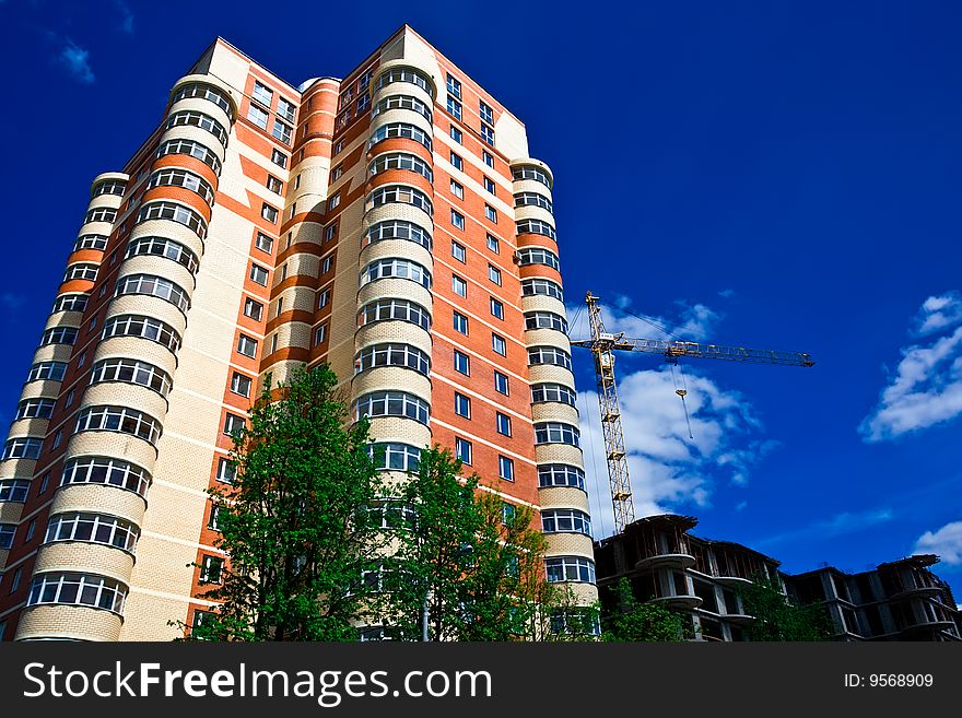 High modern apartment building under blue sky. High modern apartment building under blue sky