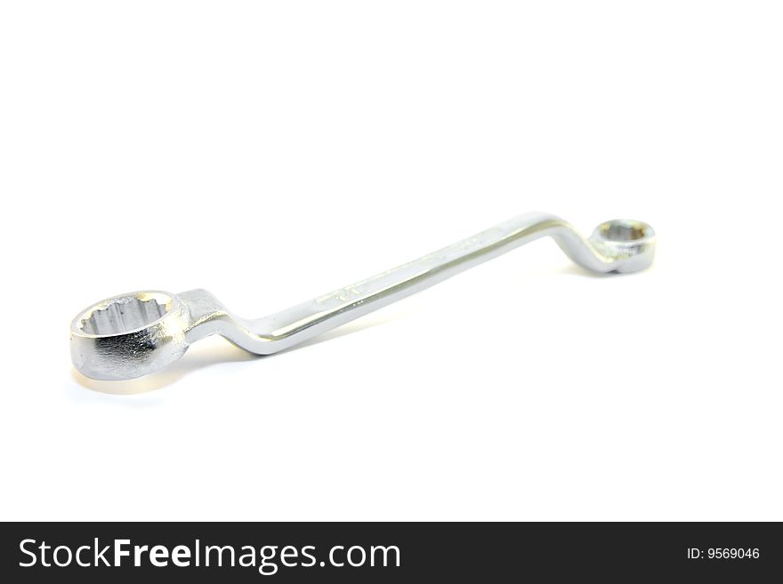 Single shiny chrome spanner on a white background