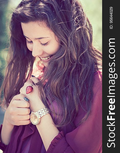 Portrait of long haired brunette woman outdoors smiling. Portrait of long haired brunette woman outdoors smiling.