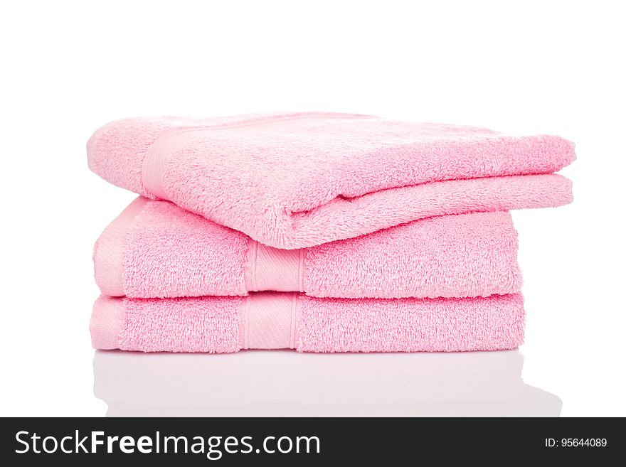 Folded pink terry cloth towels isolated on white. Folded pink terry cloth towels isolated on white.
